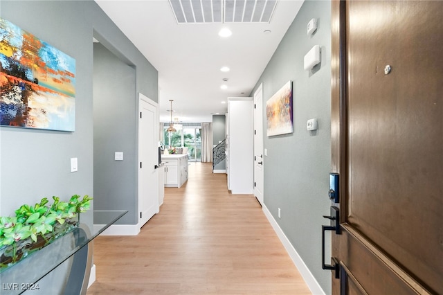 corridor with light wood-type flooring