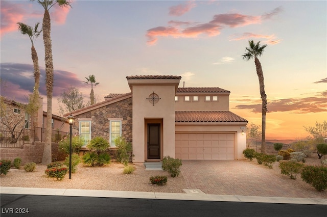 mediterranean / spanish home featuring a garage