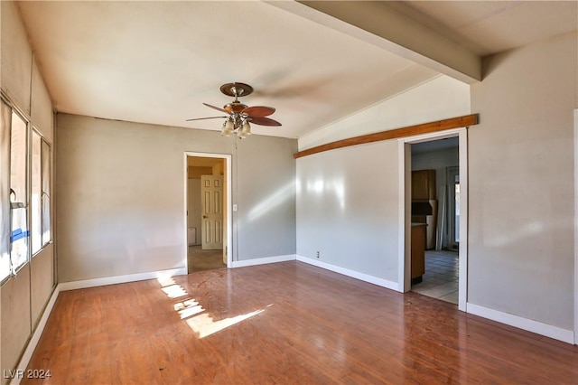 unfurnished room with hardwood / wood-style floors, vaulted ceiling with beams, and ceiling fan