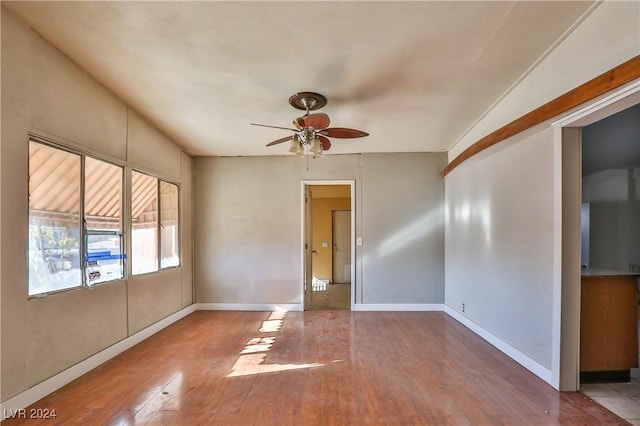 spare room with ceiling fan, wood-type flooring, and lofted ceiling