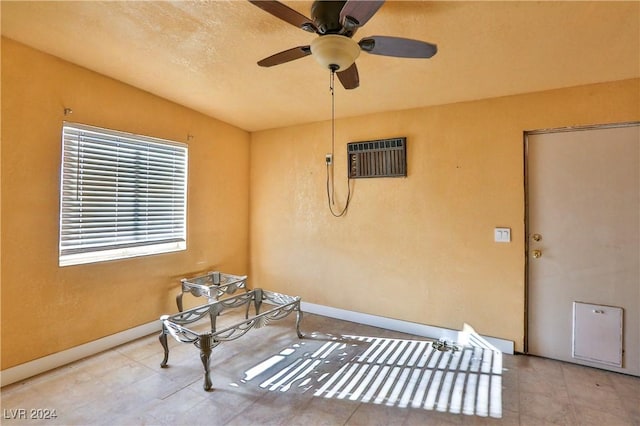 view of patio / terrace featuring ceiling fan and a wall unit AC