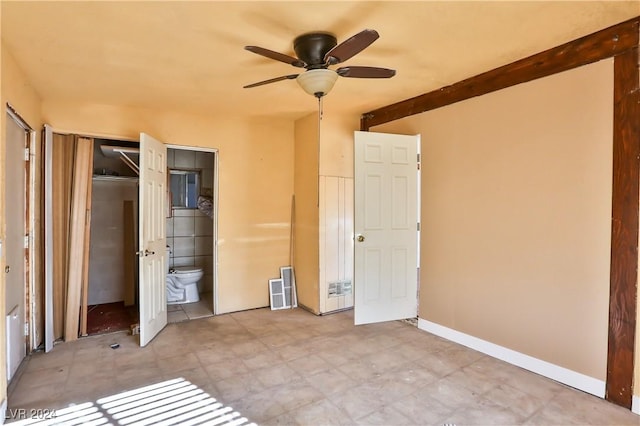 unfurnished bedroom with connected bathroom, a closet, and ceiling fan