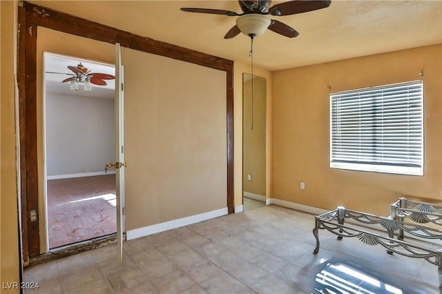 interior space with ceiling fan