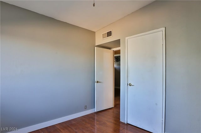 unfurnished bedroom featuring dark hardwood / wood-style flooring