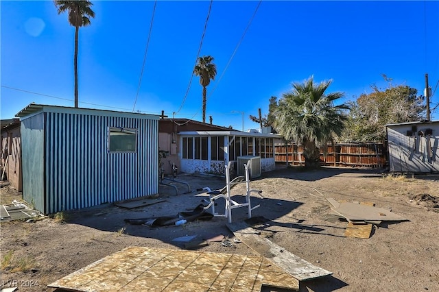 back of house featuring cooling unit