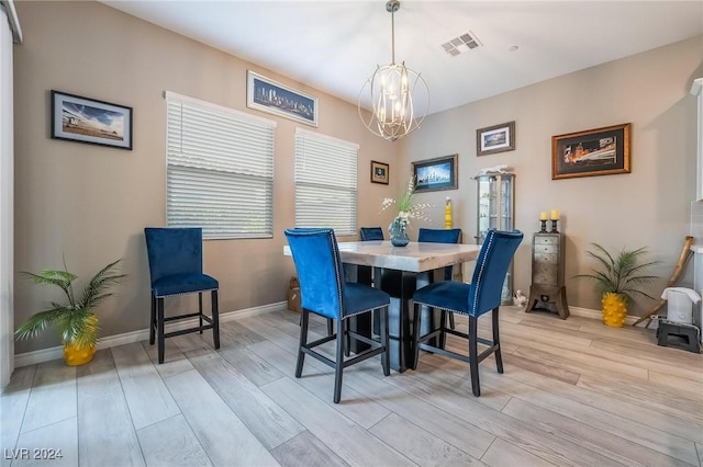 dining room featuring light hardwood / wood-style floors and a notable chandelier