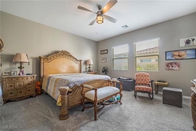 bedroom featuring ceiling fan and dark carpet