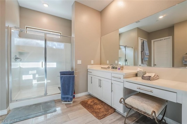 bathroom featuring vanity, hardwood / wood-style flooring, and walk in shower