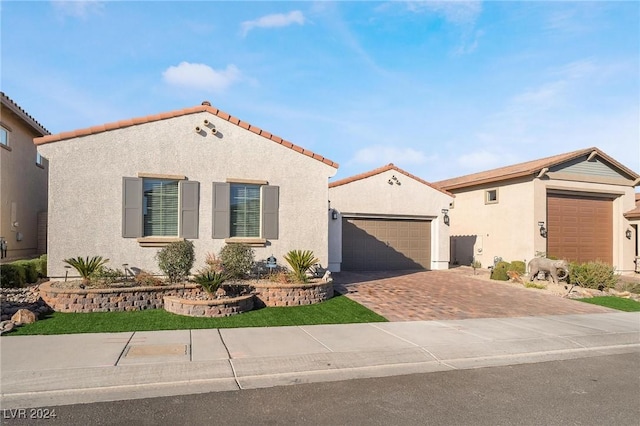 mediterranean / spanish home featuring a garage