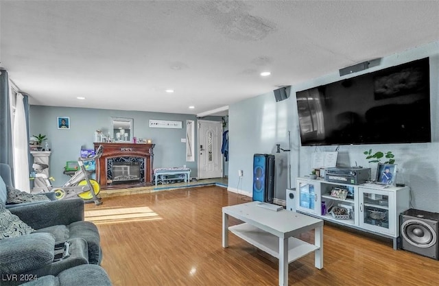 living room featuring hardwood / wood-style floors and a textured ceiling