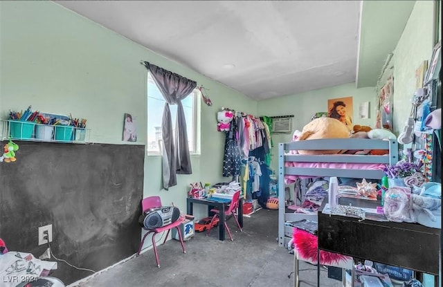 bedroom featuring concrete flooring