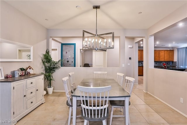 dining room featuring light tile patterned floors and a notable chandelier