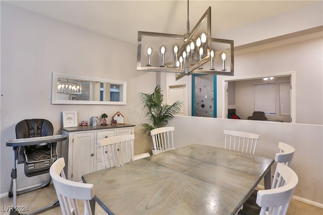 dining room with light tile patterned floors and an inviting chandelier