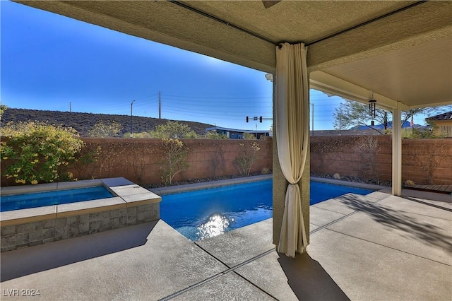 view of pool featuring an in ground hot tub and a patio