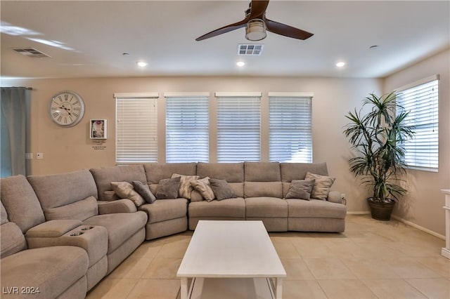 tiled living room with ceiling fan