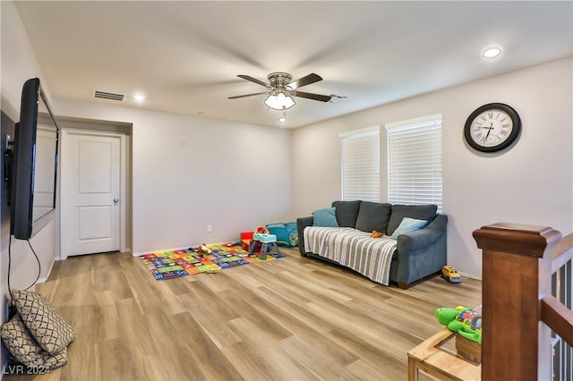 recreation room with ceiling fan and light hardwood / wood-style flooring