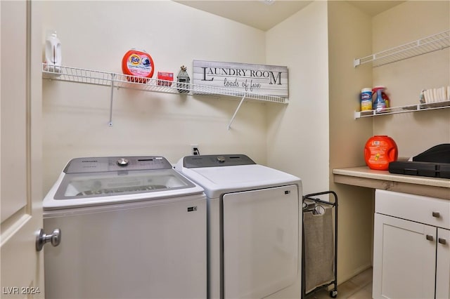 washroom with cabinets and separate washer and dryer