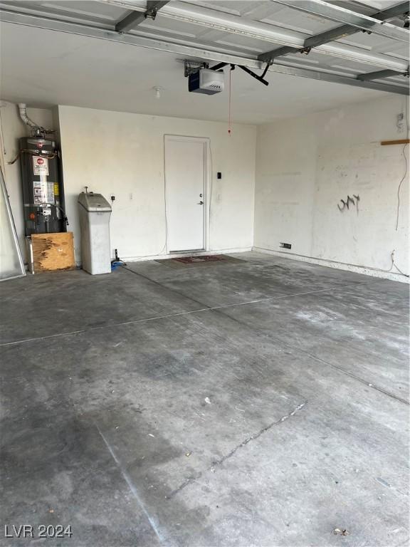 garage with a garage door opener and water heater