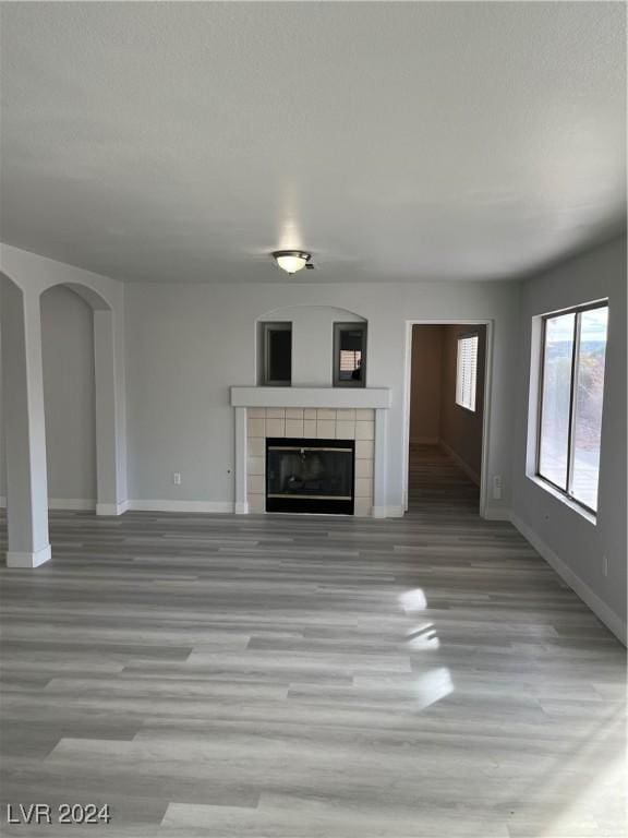 unfurnished living room with a fireplace and light hardwood / wood-style flooring