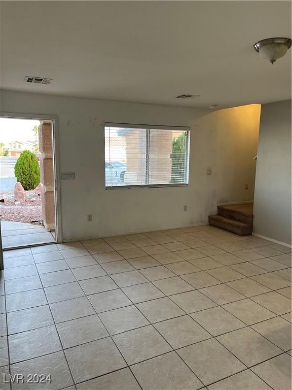 spare room with light tile patterned floors