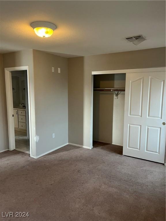 unfurnished bedroom featuring a closet and carpet