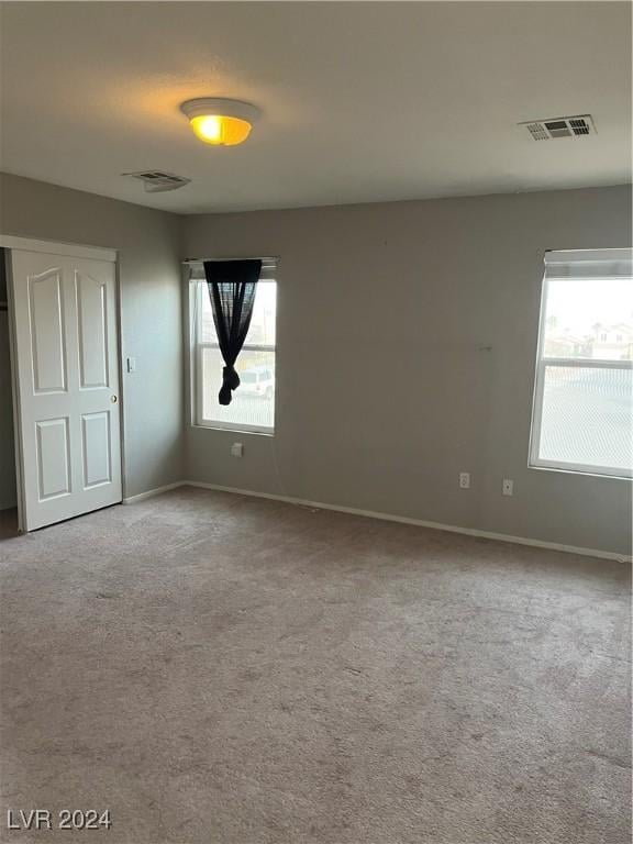 carpeted empty room featuring a healthy amount of sunlight