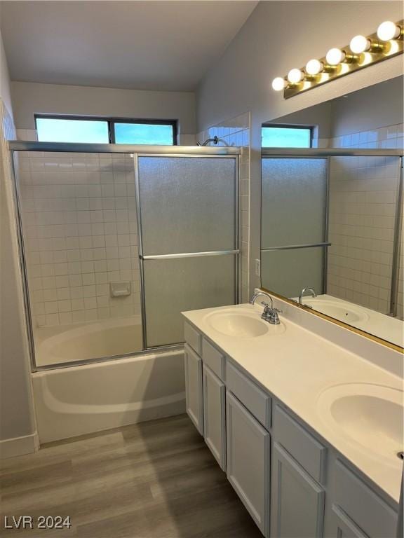 bathroom with vanity, bath / shower combo with glass door, and hardwood / wood-style flooring