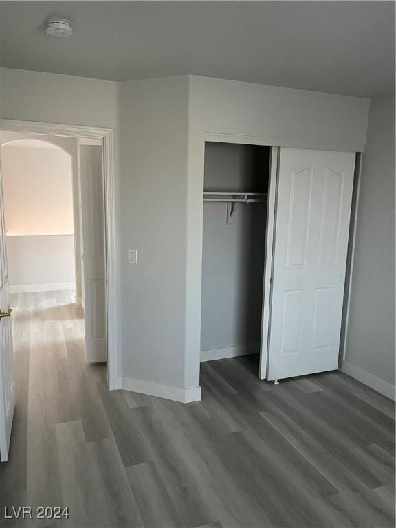 unfurnished bedroom featuring hardwood / wood-style flooring and a closet