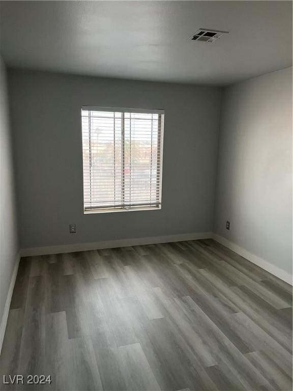 empty room with hardwood / wood-style flooring