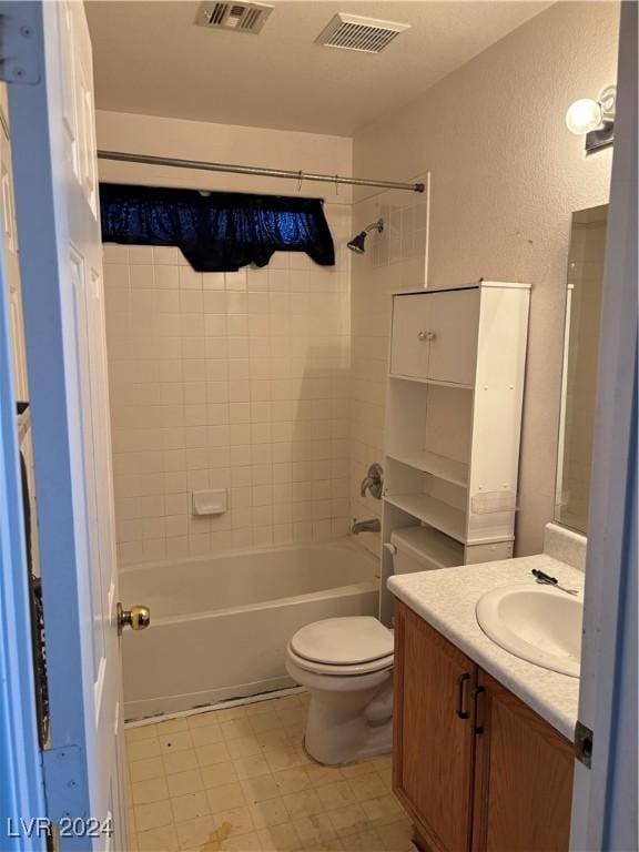 full bathroom with toilet, tiled shower / bath, and vanity