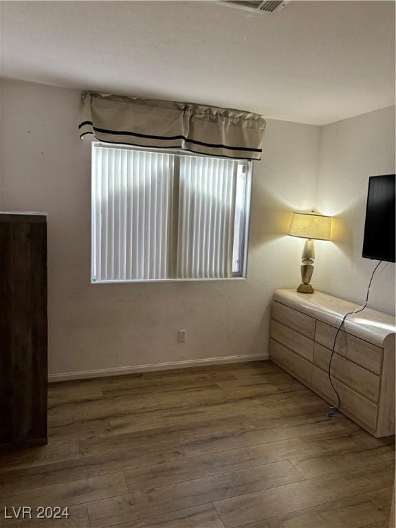 bedroom with hardwood / wood-style flooring