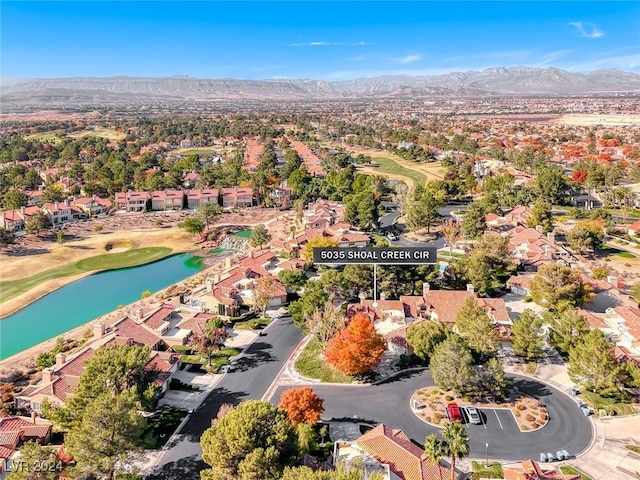 birds eye view of property with a water and mountain view