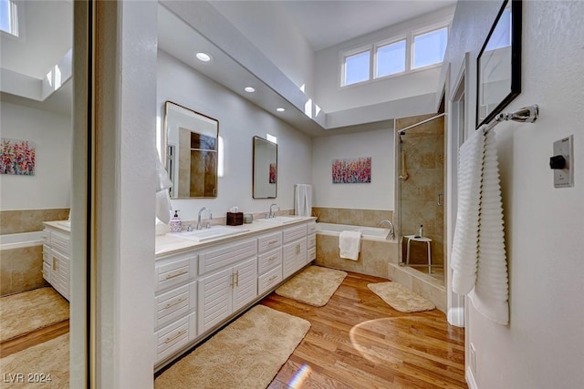 bathroom with vanity, independent shower and bath, and hardwood / wood-style flooring