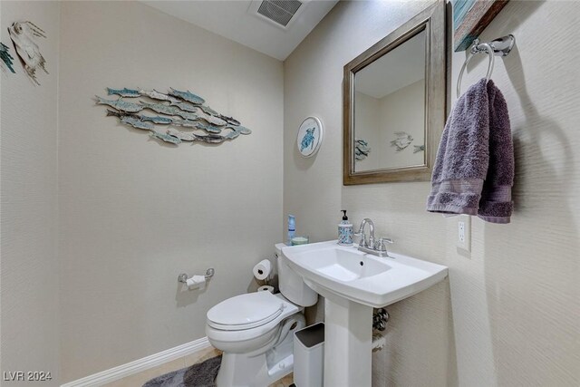 5035 Shoal Creek Cir, Las Vegas, NV 89113 - half bath featuring toilet, baseboards, and tile patterned floors
