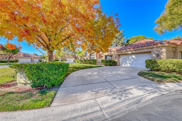 5035 Shoal Creek Cir, Las Vegas, NV 89113 - view of front of property featuring a tiled roof, an attached garage, stucco siding, and driveway