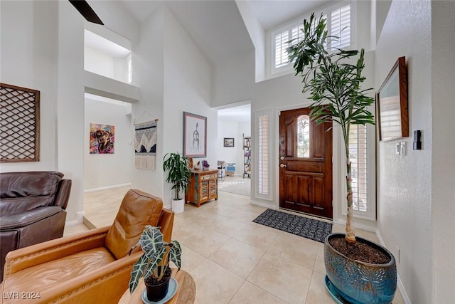 tiled foyer entrance featuring a high ceiling and a wealth of natural light