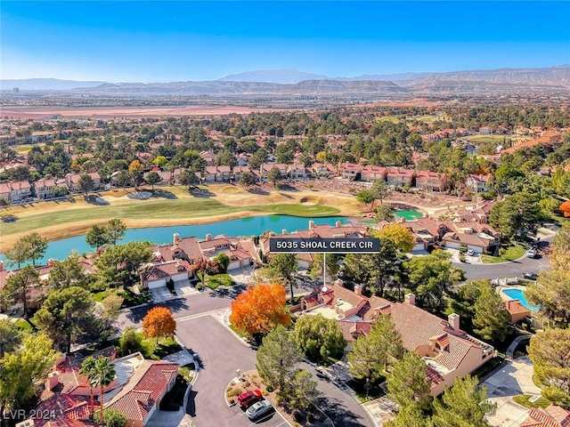 drone / aerial view with a water and mountain view