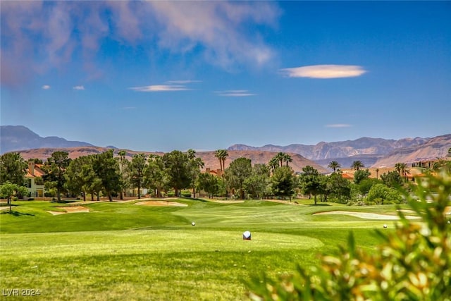 surrounding community featuring a lawn and a mountain view