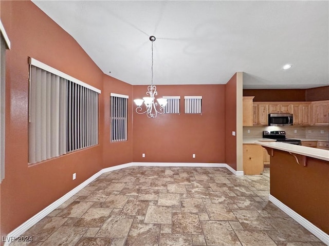 kitchen with a breakfast bar, hanging light fixtures, stainless steel appliances, a chandelier, and light brown cabinetry