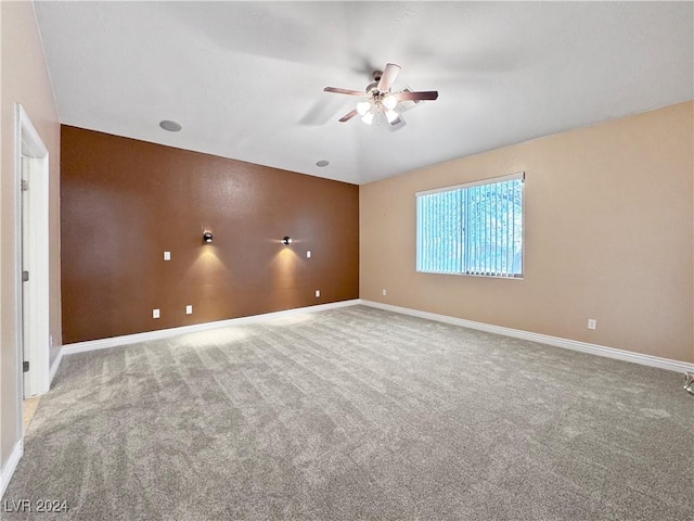 spare room with ceiling fan and carpet