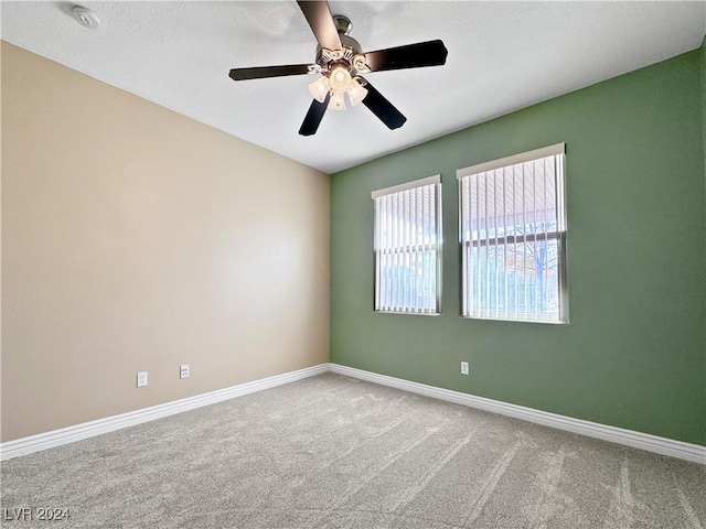 spare room featuring ceiling fan and carpet floors