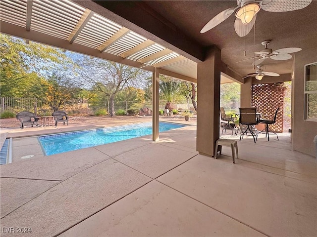 view of swimming pool with ceiling fan and a patio