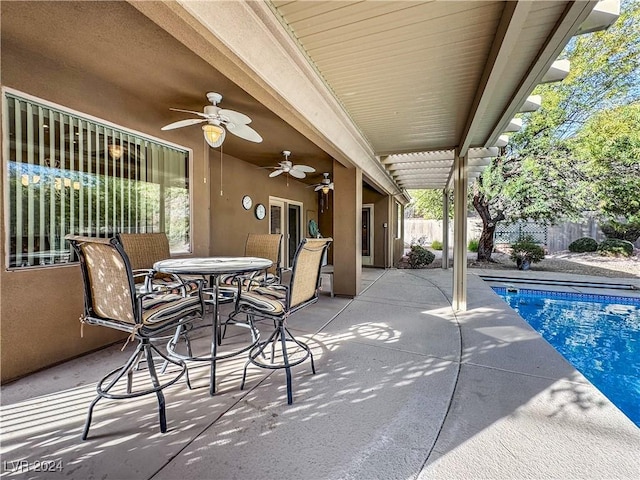 view of patio / terrace with a fenced in pool and ceiling fan