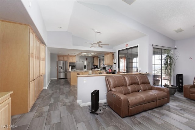 living room featuring a textured ceiling, vaulted ceiling, and ceiling fan