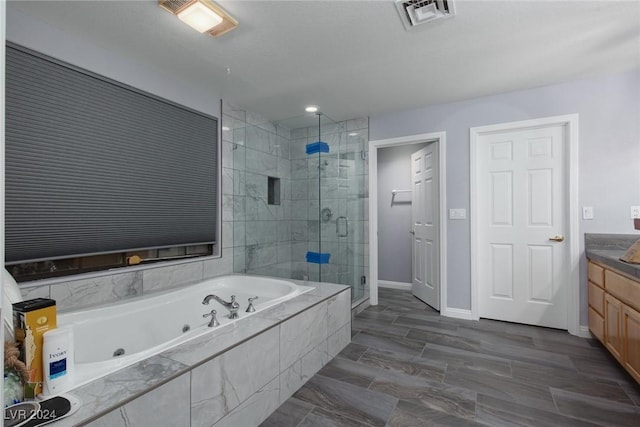 bathroom with vanity and separate shower and tub