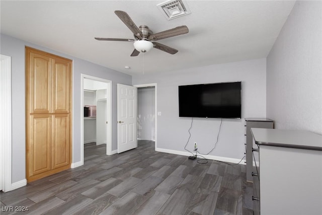 interior space with ceiling fan and dark hardwood / wood-style flooring