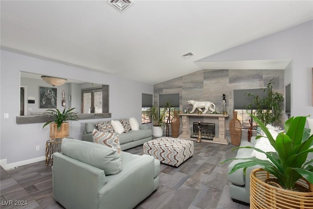 living room featuring a fireplace, lofted ceiling, and dark wood-type flooring