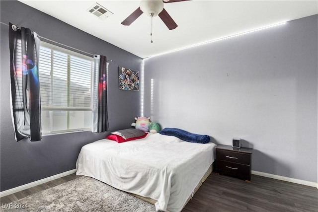 bedroom with ceiling fan and dark wood-type flooring