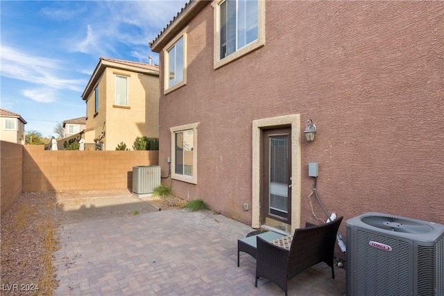 exterior space with central AC unit and a patio area