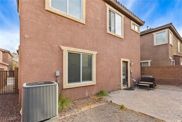 back of house featuring a patio area and central AC